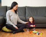 Woman on floor pillow with child