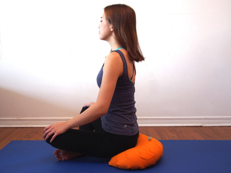 Meditating on zafu cushion