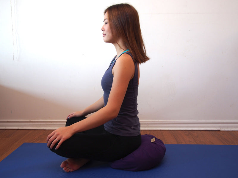 Meditating on zafu cushion