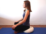 Meditating on zafu cushion