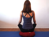 Meditating on zafu cushion